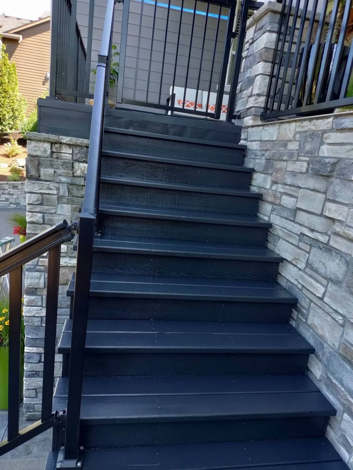 Exterior stone staircase with dark stained treads