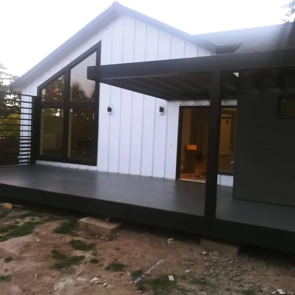 White farmhouse-style exterior with black window frames